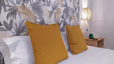 a bedroom with a bed with two yellow pillows at Sherryflat Caballeros - Parking in Jerez de la Frontera
