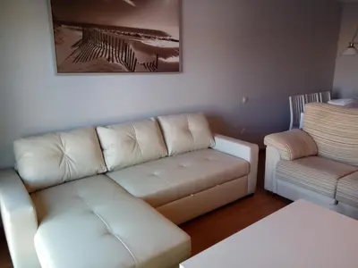 a living room with a couch and a chair at Apartamento La Ermita Wifi in Jerez de la Frontera