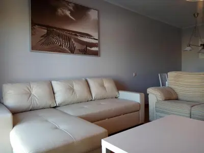 a living room with a couch and a chair at Apartamento La Ermita Wifi in Jerez de la Frontera