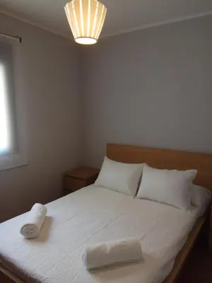 a bedroom with a bed with two towels on it at Apartamento La Ermita Wifi in Jerez de la Frontera