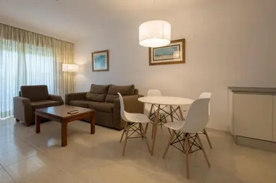 a living room with a couch and a table at Aparthotel las Dunas in Chiclana de la Frontera
