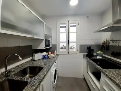 a kitchen with a sink and a counter top at Casa Caleta a 2 minutos de la playa in Cádiz