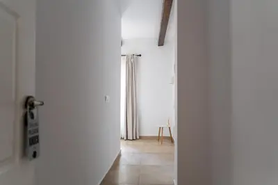 an open door to a white room with a window at Moorea Boutique - Only Adults in Chiclana de la Frontera