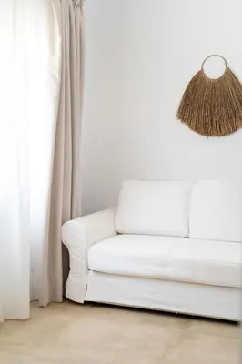 a white couch in a living room with a lamp at Moorea Boutique - Only Adults in Chiclana de la Frontera