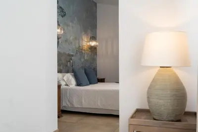 a bedroom with a bed and a table with a lamp at Moorea Boutique - Only Adults in Chiclana de la Frontera
