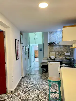 a kitchen with blue cabinets and a tile floor at Rosa de los Vientos in Cádiz