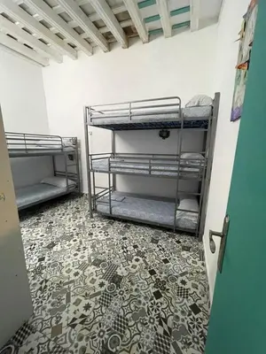 two bunk beds in a room with a tile floor at Rosa de los Vientos in Cádiz