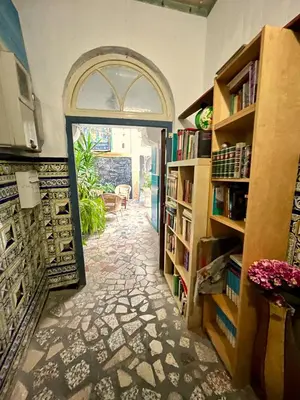 an entrance to a library with an archway and book shelves at Rosa de los Vientos in Cádiz