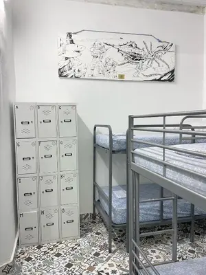 a room with two bunk beds and a painting on the wall at Rosa de los Vientos in Cádiz