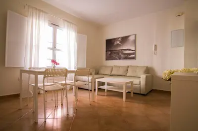 a living room with a couch and a table at Apartamentos Centro 2 el Puerto in El Puerto de Santa María