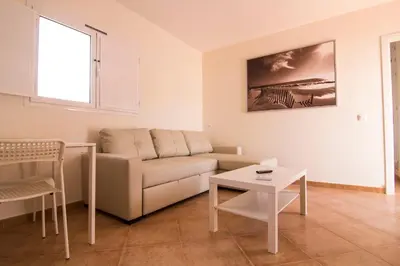 a living room with a couch and a table at Apartamentos Centro 2 el Puerto in El Puerto de Santa María