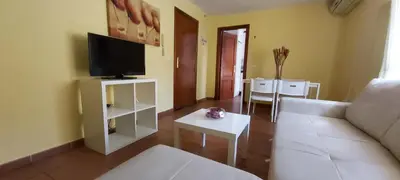 a living room with a white couch and a tv at Apartamento Cielo 35 in El Puerto de Santa María