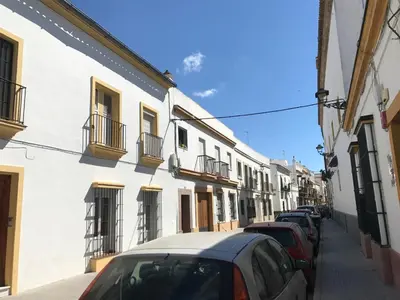 a row of cars parked on a street with buildings at Apartamento Cielo 35 in El Puerto de Santa María