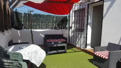 a balcony with a table and chairs and a table at Casa Paco in Chiclana de la Frontera
