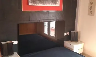 a bedroom with a bed and a window in a room at Casa Paco in Chiclana de la Frontera