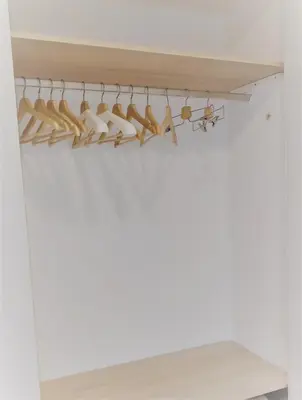 a closet with white walls and a rack of shoes at El Mirador de Cadiz in Cádiz