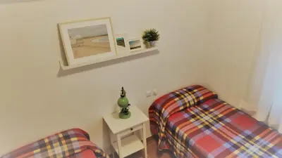 a room with two beds and a mirror on the wall at El Mirador de Cadiz in Cádiz