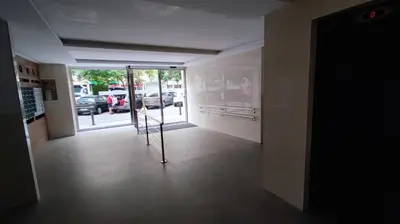 a hallway with a door to a parking lot with cars at El Mirador de Cadiz in Cádiz
