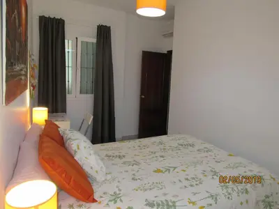 a living room with a couch and a table with a television at Apartamento Alameda in Cádiz