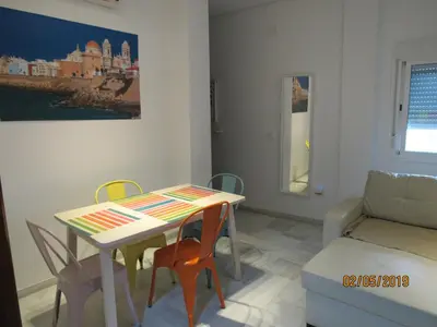 a living room with a couch and a tv at Apartamento Alameda in Cádiz