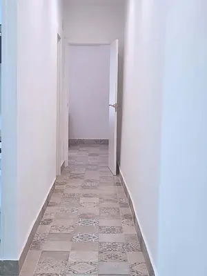 an empty hallway with a white door and a tile floor at Playa de la Caleta, Cadiz in Cádiz