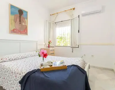 a white bedroom with a bed with a tray on it at Charming house in Arcos with private pool in Arcos de la Frontera