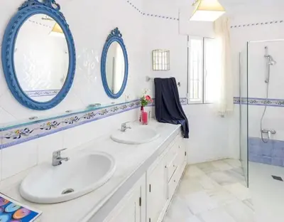a bathroom with two sinks and a mirror at Charming house in Arcos with private pool in Arcos de la Frontera