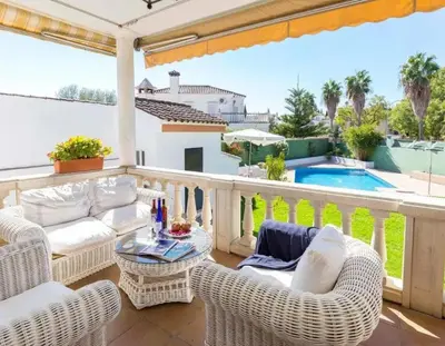 a patio with wicker chairs and a table and a pool at Charming house in Arcos with private pool in Arcos de la Frontera