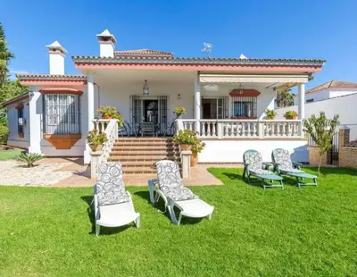 a group of lawn chairs in front of a house at Charming house in Arcos with private pool in Arcos de la Frontera