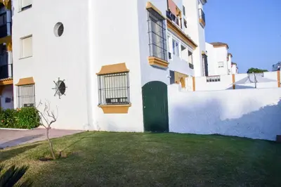 a patio with a table and chairs and an umbrella at Vem Al Puerto De Santa Maria in El Puerto de Santa María