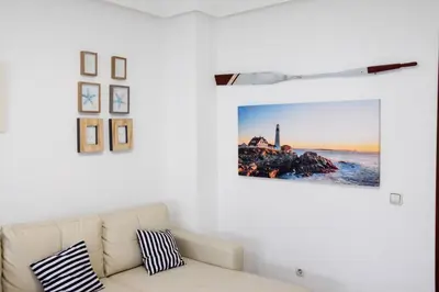 a bedroom with two beds and a sink and windows at Vem Al Puerto De Santa Maria in El Puerto de Santa María