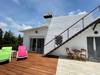 a deck with chairs and a table on a house at Chalet El Molino in Chiclana de la Frontera
