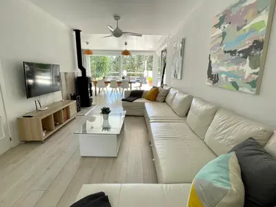 a living room with a white couch and a table at Chalet El Molino in Chiclana de la Frontera