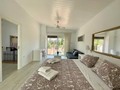 a bedroom with a large bed with towels on it at Chalet El Molino in Chiclana de la Frontera
