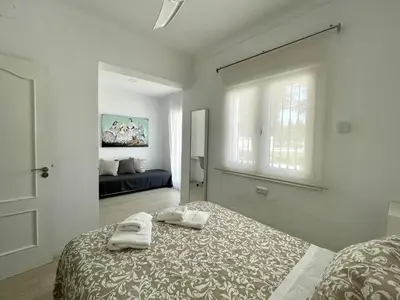 a bedroom with a bed with two towels on it at Chalet El Molino in Chiclana de la Frontera