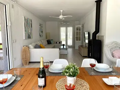 a living room with a table with wine glasses at Chalet El Molino in Chiclana de la Frontera
