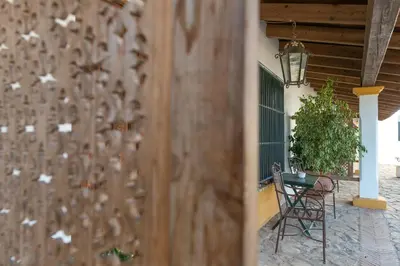a fence with white butterflies on it next to a table at Cortijo Los Monteros in Benalup Casas Viejas