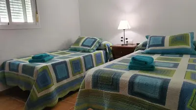 two beds sitting next to each other in a room at El chalet del Mar in Chiclana de la Frontera