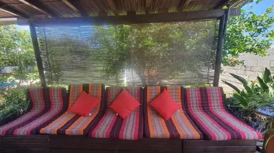 a colorful couch with four pillows on a patio at El chalet del Mar in Chiclana de la Frontera