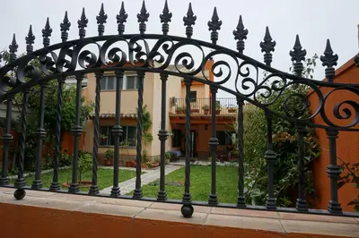 a black wrought iron fence in front of a house at Villa Valdelagrana fantástica para familias in Cádiz