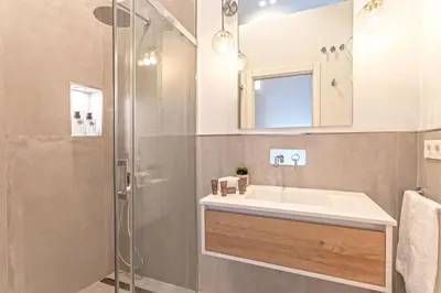 a bathroom with a sink and a shower at Genteel Home Plaza de España Cádiz in Cádiz