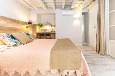 a bedroom with a large bed in a room at Genteel Home Plaza de España Cádiz in Cádiz