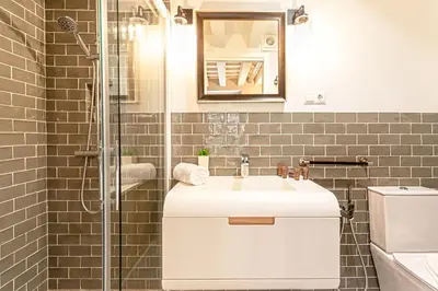 a bathroom with a sink and a shower at Genteel Home Plaza de España Cádiz in Cádiz