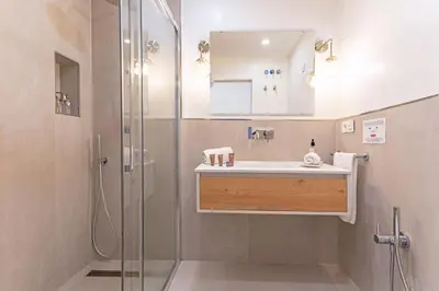 a bathroom with a sink and a shower at Genteel Home Plaza de España Cádiz in Cádiz