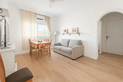 a living room with a couch and a table at Apartamento con Vistas al González Byass in Jerez de la Frontera