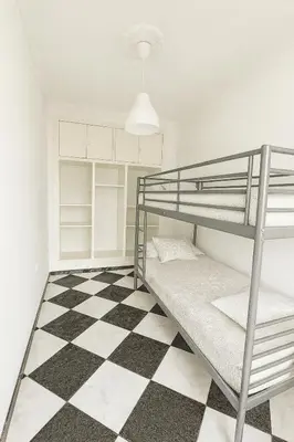 a bedroom with a bunk bed and a checkered floor at Apartamento con Vistas al González Byass in Jerez de la Frontera
