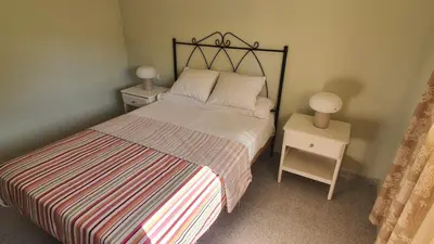 a bedroom with a bed with two night stands and two lamps at Apartment in Rota Cadiz, terrace AC wifi in Rota