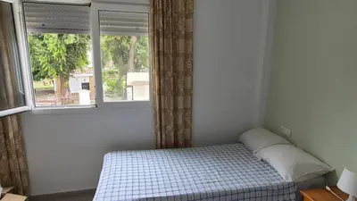 a bedroom with a bed in front of a window at Apartment in Rota Cadiz, terrace AC wifi in Rota