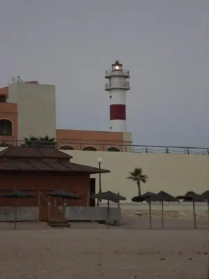 a light house with a red and white lighthouse at Apartment in Rota Cadiz, terrace AC wifi in Rota