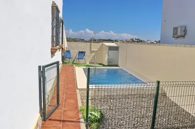 a view of a swimming pool from the balcony of a house at Chalet Chaparrillo Conil in Conil de la Frontera